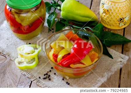 Home preservation. Vegetable salad in a jar on a wooden table.  79224985