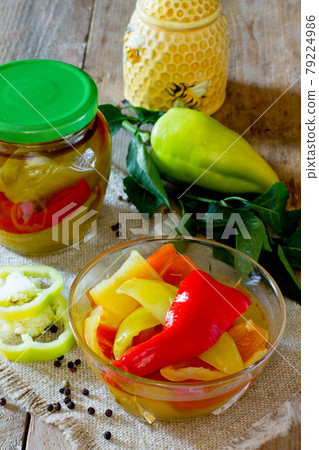 Home preservation. Vegetable salad in a jar on a wooden table. Home preservation. Vegetable salad in a jar on a wooden table. 79224986