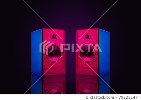 Two stereo speakers with neon light on dark background 79225147