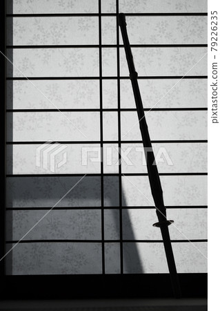 Silhouette of a bamboo sword on a shoji Silhouette of a bamboo sword on a shoji 79226235