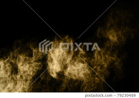 Golden powder explosion on black background. Freeze motion. 79230489