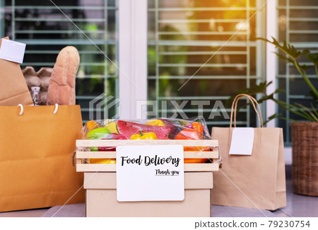 Delivery food service in wooden box or paper bag for customer during corona virus or covid-19 spreading at front door house Delivery food service in wooden box or paper bag for customer during corona virus or covid-19 spreading at front door house 79230754