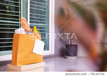 Delivery food service in paper bag for customer during corona virus or covid-19 spreading at front door home 79230756