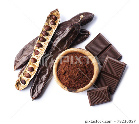 Carob pod and carob powder on white backgrounds. 79236057