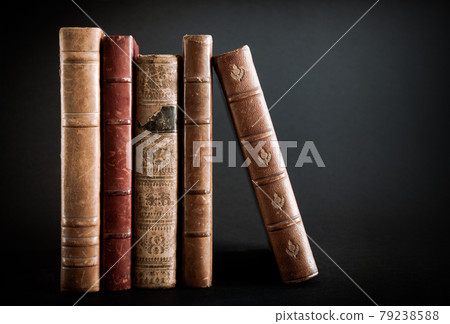 Row of old books on black background Row of old books on black background 79238588