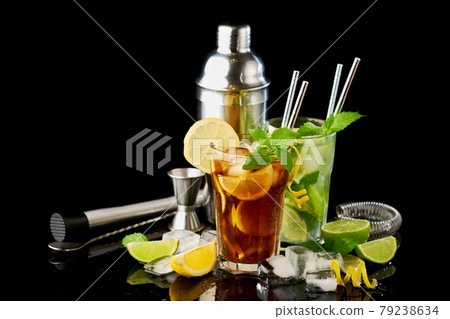 Glass of Fresh Long Island Ice Tea and Mojito Cocktail - studio shot on black background 79238634