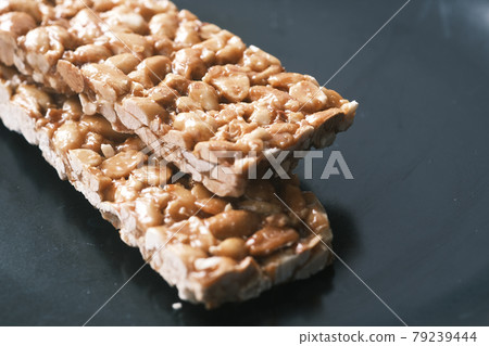 pea nuts sweet bar on a plate close up  79239444