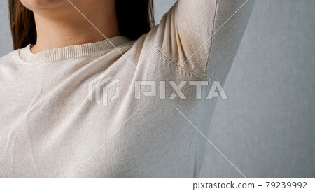 Wet armpit of an unrecognizable woman. Stress concept, hormonal disruption 79239992