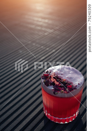 clover club cocktail drink with raspberry and rose petal outdoor at sunset clover club cocktail drink with raspberry and rose petal outdoor at sunset 79240309