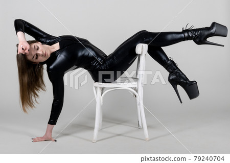 Sexy beautiful woman pole dancer posing in latex costume on background. Easter bunny concept. Sexy beautiful woman pole dancer posing in latex costume on background. Easter bunny concept. 79240704