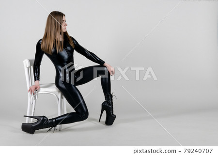 Sexy beautiful woman pole dancer posing in latex costume on background. Easter bunny concept. 79240707