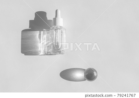 Anti aging serum with collagen and peptides on white surface with sunlight and shadow. Hyaluronic acid oil mockup. Serum cosmetic. Anti aging serum with collagen and peptides on white surface with sunlight and shadow. Hyaluronic acid oil mockup. Serum cosmetic. 79241767