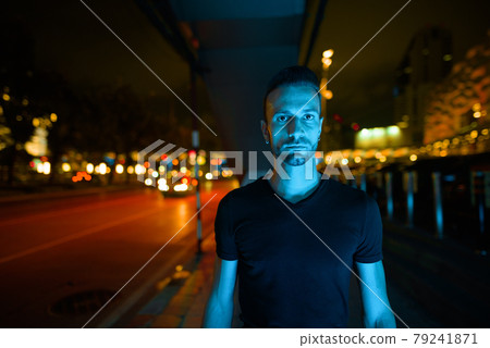 Portrait of handsome man at night in city streets Portrait of handsome man at night in city streets 79241871