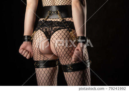 Sexy lady in bdsm outfit. 79241992