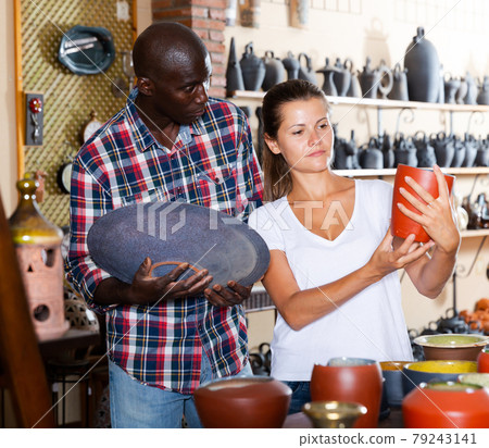 Man and woman choose ceramic dishes in the store Man and woman choose ceramic dishes in the store 79243141
