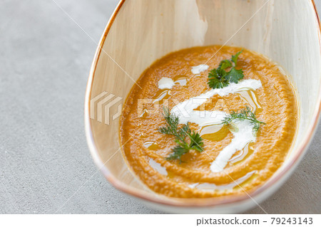 Vegetable cream soup in bowl on gray table Vegetable cream soup in bowl on gray table 79243143