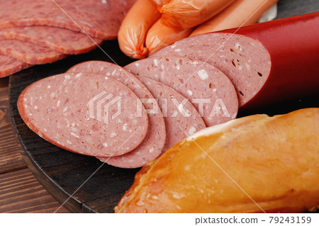 Variety of meat and sausage products on table 79243159