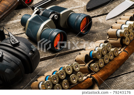 Hunting equipment binoculars on wooden background close up Hunting equipment binoculars on wooden background close up 79243176