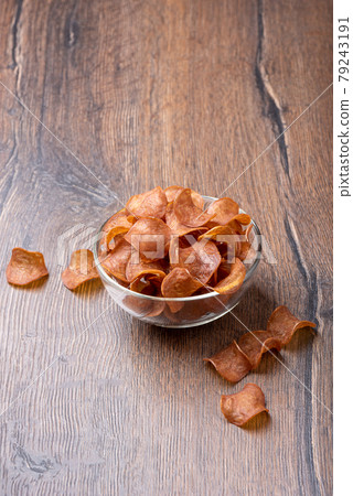 Jerky in a glass bowl on a wooden background. Jerky in a glass bowl on a wooden background. 79243191
