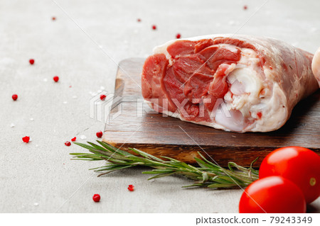 Raw lamb shanks on wooden board close up 79243349