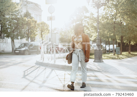 Young african american woman crossing the street 79243460
