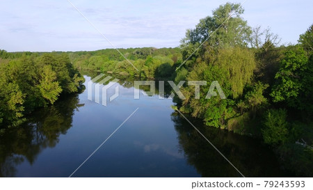 Aerial drone view flight over mirror smooth surface of river and trees Aerial drone view flight over mirror smooth surface of river and trees 79243593