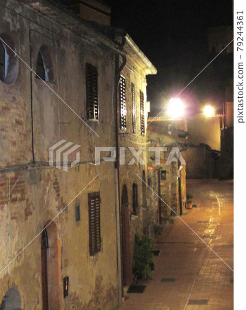 Italy / San Gimignano Old brick cityscape with street lights Night view 79244361