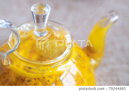 Close up teapot with orange buckthorn tea inside Close up teapot with orange buckthorn tea inside 79244865