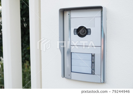 white intercom with a camera on the door of a private house white intercom with a camera on the door of a private house 79244946