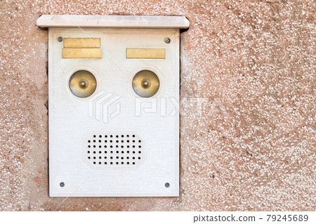 White old intercom with buttons for a call. White old intercom with buttons for a call. 79245689