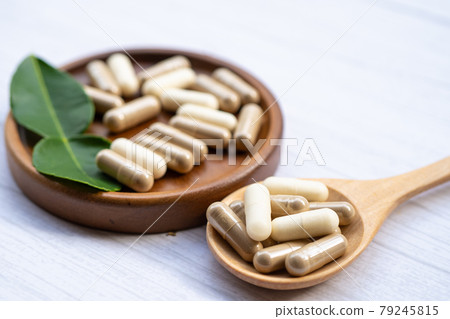 Alternative medicine herbal organic capsule with vitamin mineral, drug with herbs leaf natural supplements for healthy good life. Alternative medicine herbal organic capsule with vitamin mineral, drug with herbs leaf natural supplements for healthy good life. 79245815