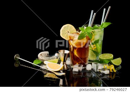 Glass of Fresh Long Island Ice Tea and Mojito Cocktail - studio shot on black background Glass of Fresh Long Island Ice Tea and Mojito Cocktail - studio shot on black background 79246027