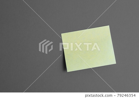 Yellow paper sticker on black and white background. 79246354
