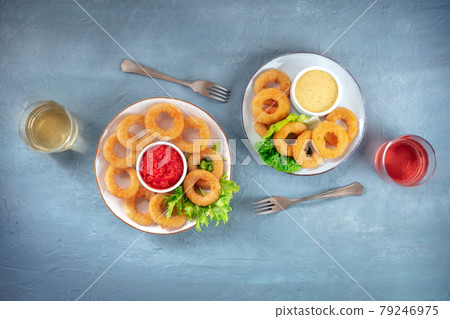 Calamari rings. Deep fried squid rings with wine and various dips, overhead shot 79246975