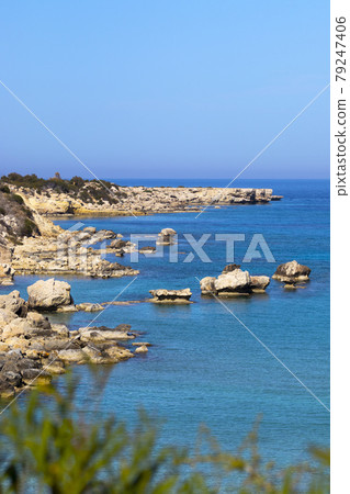 Mediterranean sea beach. Stones and Rocks. Summer day seascape. Clear Water texture. Aerial view, sunny day over sea or ocean. Vertical Photo. Nature wallpaper. Mediterranean sea beach. Stones and Rocks. Summer day seascape. Clear Water texture. Aerial view, sunny day over sea or ocean. Vertical Photo. Nature wallpaper. 79247406