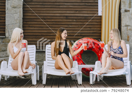 Three elegant girls on a resort 79248074