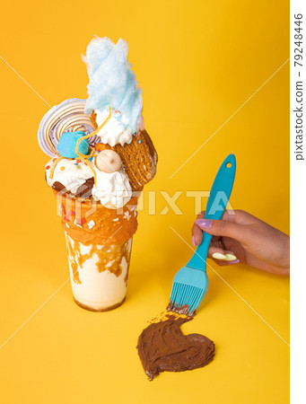 Chocolate milkshake decorated with marshamallows and cookies. Chocolate milkshake decorated with marshamallows and cookies. 79248446