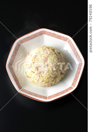 A bird's-eye view of hot Gomoku fried rice with various ingredients such as Narutomaki and char siu on a black background A bird's-eye view of hot Gomoku fried rice with various ingredients such as Narutomaki and char siu on a black background 79248596