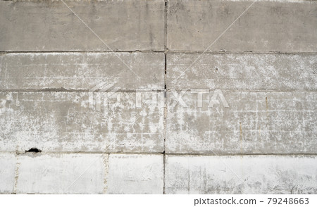 Old grungy grey concrete wall texture with a holes and seams. Old grungy grey concrete wall texture with a holes and seams. 79248663