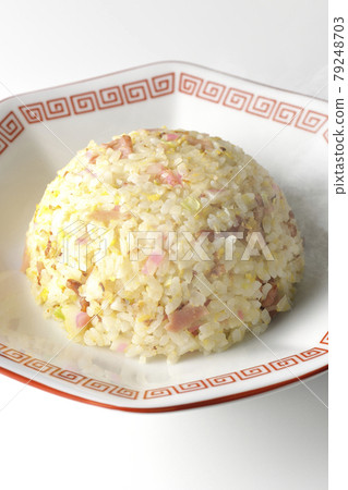A hot five-eyed fried rice with various ingredients such as Narutomaki and char siu taken on a white background 79248703