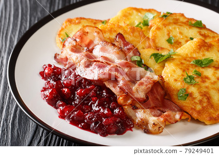 Swedish potato pancakes with fried pork raggmunk med flask close-up in a plate. horizontal 79249401