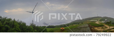 Wind turbines and astronomical observatory on a cloud-covered mountaintop 79249922