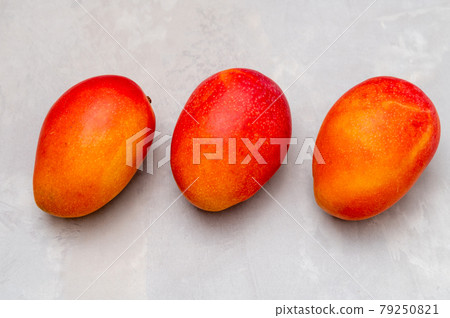 Mango on a wooden plate 79250821
