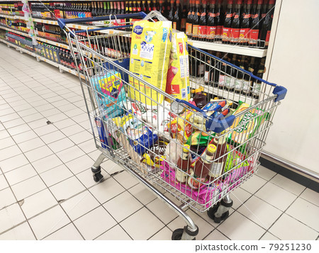 PENANG, MALAYSIA - MARCH 29, 2021: Groceries that have been picked up are placed in the cart before payment is made at the payment counter. Shopping carts make it easy for customers to shop. 79251230