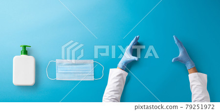 Hands with gloves, face mask and antiseptic gel, covid-19 concept. Copy space. Hands with gloves, face mask and antiseptic gel, covid-19 concept. Copy space. 79251972