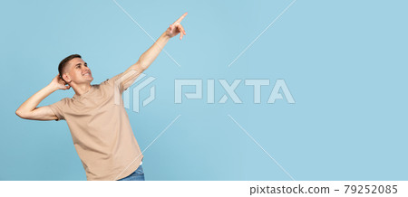Portrait of young Caucasian man posing isolated over blue studio background with copyspace for ad. Concept of human emotions Portrait of young Caucasian man posing isolated over blue studio background with copyspace for ad. Concept of human emotions 79252085