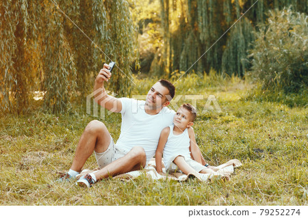 Cute family playing in a summer field Cute family playing in a summer field 79252274