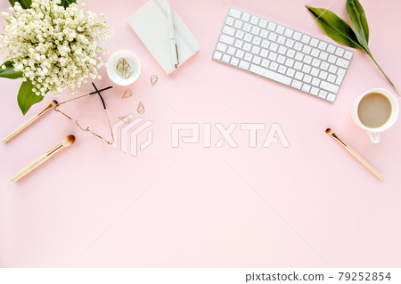 Office table desk with computer, lilac, clipboard. magazines. Top view Flat lay. Home office workspace. Women's fashion accessories on pink background Office table desk with computer, lilac, clipboard. magazines. Top view Flat lay. Home office workspace. Women's fashion accessories on pink background 79252854