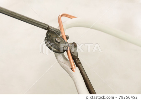 Man hands bends copper pipes by pipe bender. Man hands bends copper pipes by pipe bender. 79256452