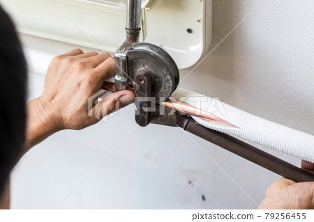 Man hands bends copper pipes by pipe bender. Man hands bends copper pipes by pipe bender. 79256455